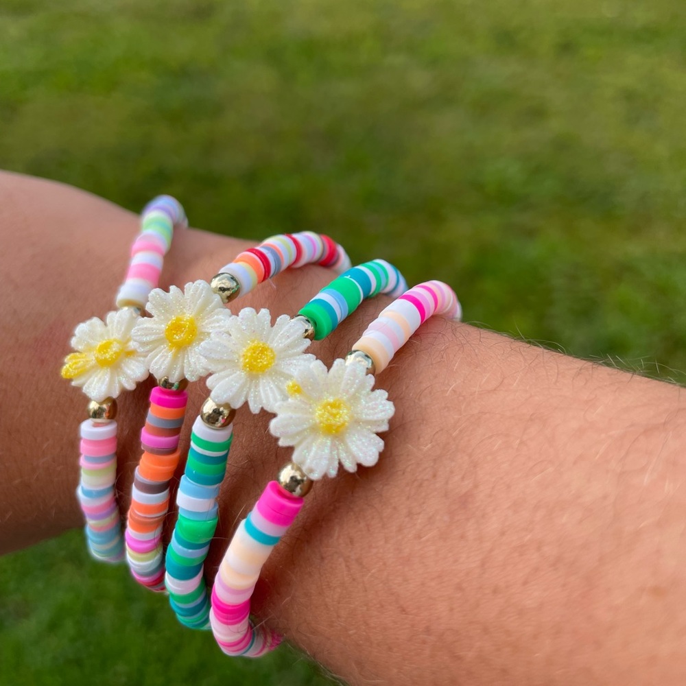 Flower colorful clay bead bracelets. You get all 4 of these stackable brackets.